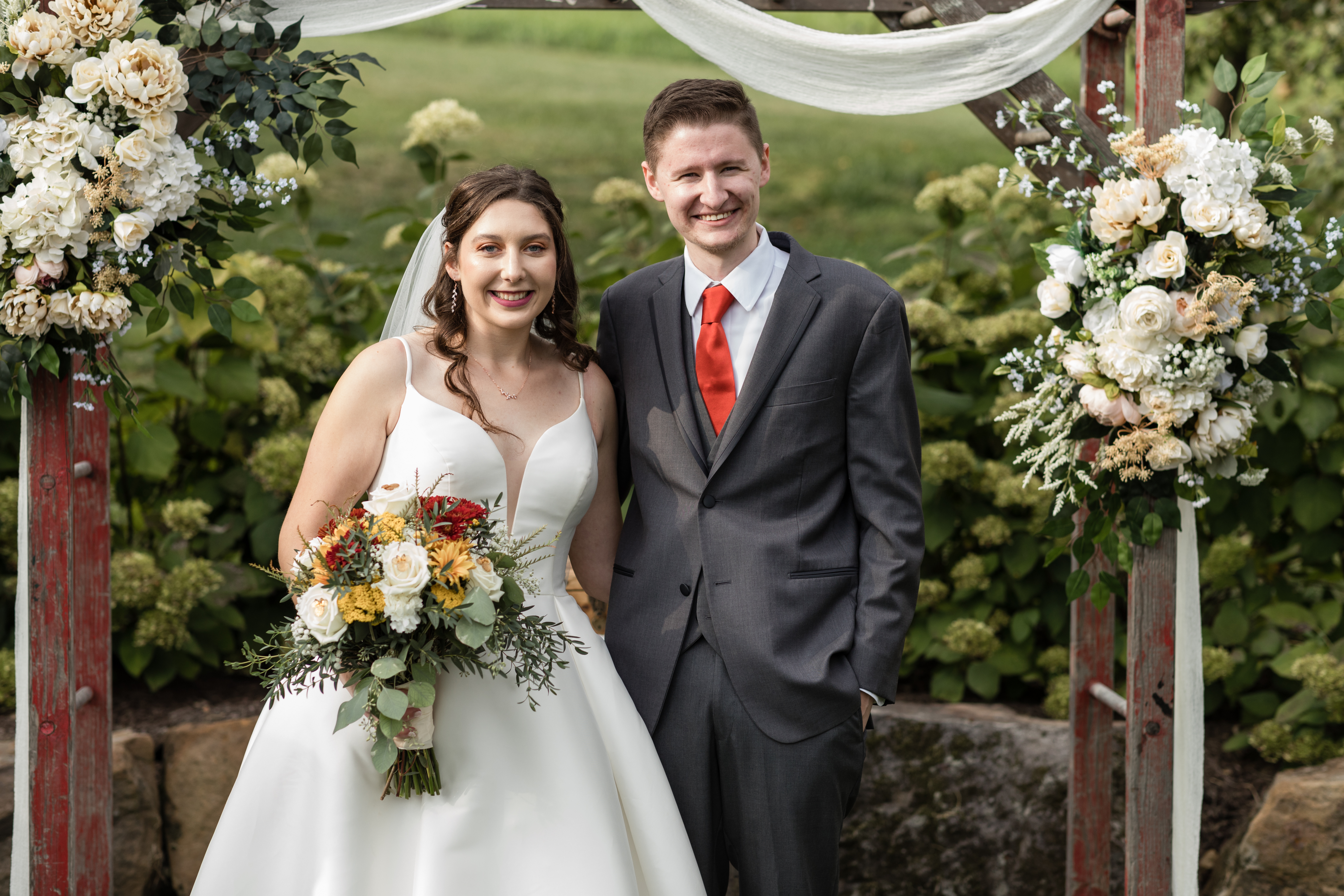 Mohican Media - Bride and Groom under arch in Orchard at White Pine Grove