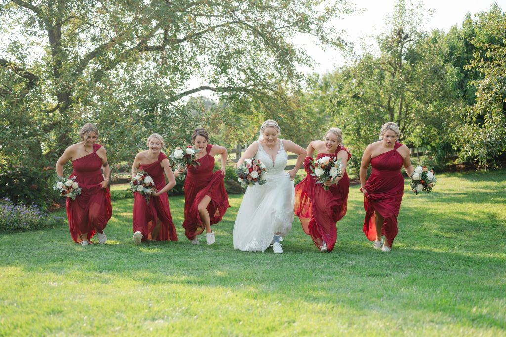 Samantha Walker Photography - Bride and Bridesmaids running in Orchard at White Pine Grove